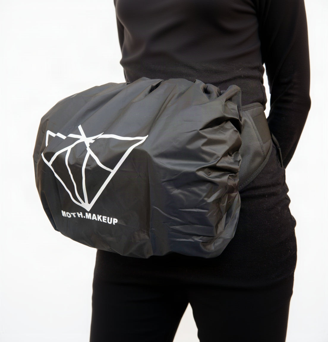 Tailored all-weather rain cover for the Moth Pro bag, worn at the waist, Moth Makeup branding visible