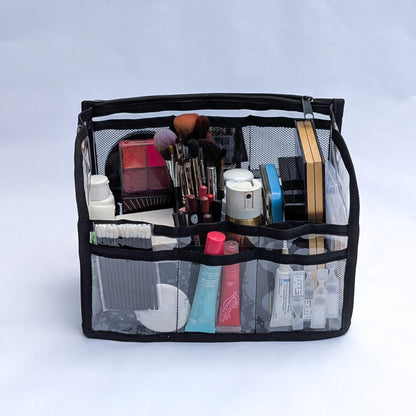 PVC insert for Moth Pro bag, front view, filled with makeup palettes, brushes and tubes