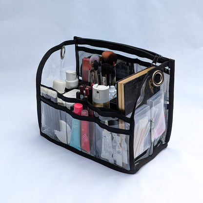 PVC insert for Moth Pro bag, filled with bottles, brushes and a compact mirror in its compartments