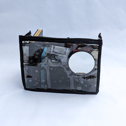 PVC insert for Moth Pro bag, folded flat showing the built-in circular mirror on the back panel