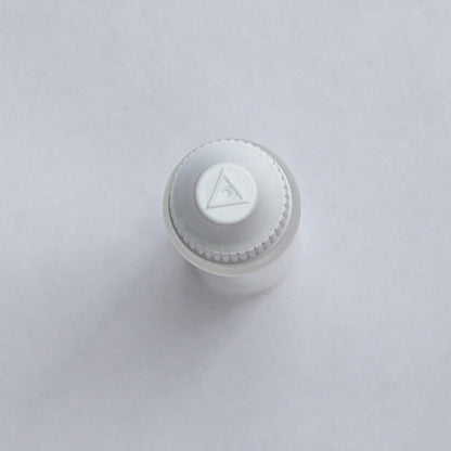 Long dropper bottle cap close-up from above, showing the embossed logo detail