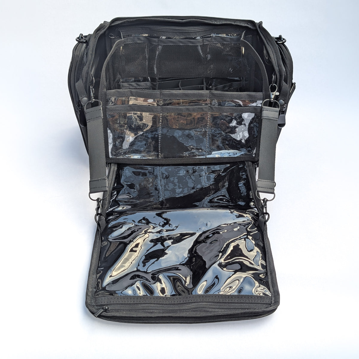 Moth Pro set bag with with multiple clear plastic and mesh pockets, shown against a light gray studio background.