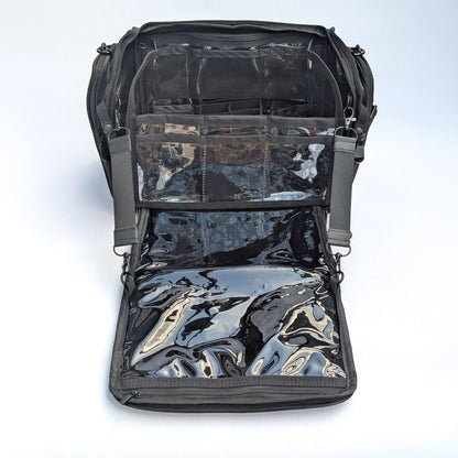 Moth Pro set bag with with multiple clear plastic and mesh pockets, shown against a light gray studio background.