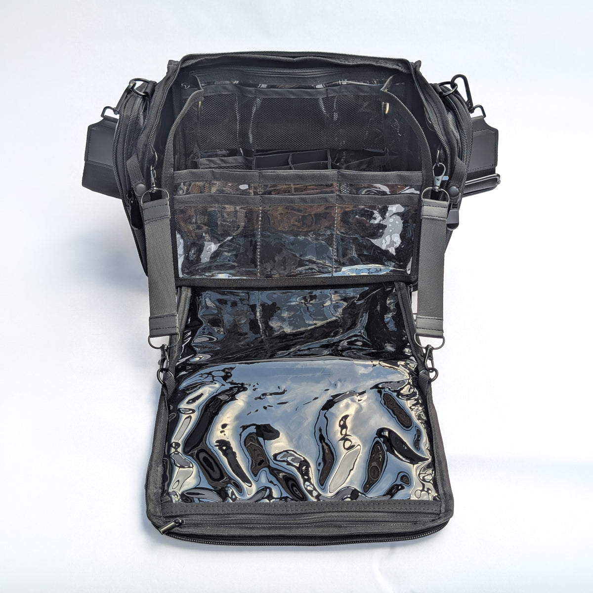 Moth Pro set bag with multiple zippered compartments and clear plastic pockets, photographed against a white background.
