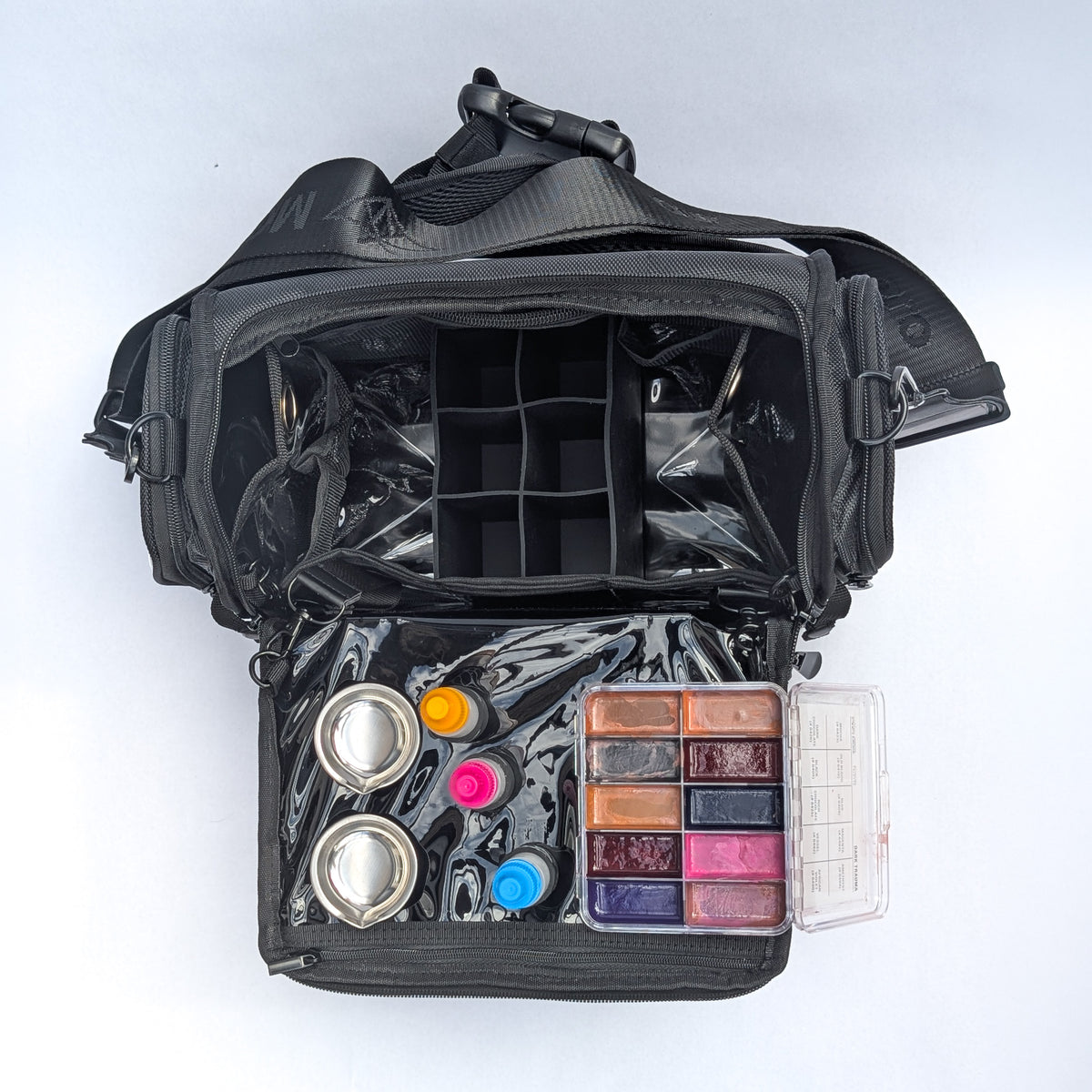 Moth Pro set bag overhead flat lay, showing the divided upper tray and filled lower tray