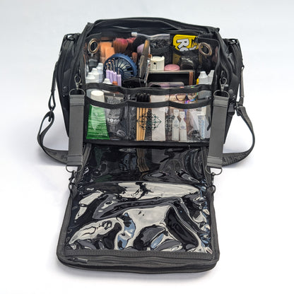 Moth Pro set bag with cosmetics and accessories, photographed on a clean white studio background. The bag has multiple compartments, mesh pockets, and a glossy black interior lining.