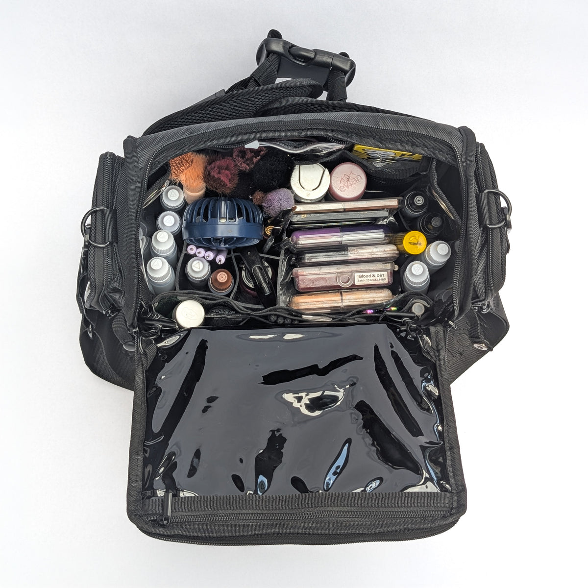 Moth Pro set bag filled with cosmetics and accessories, photographed from above on a plain white background.